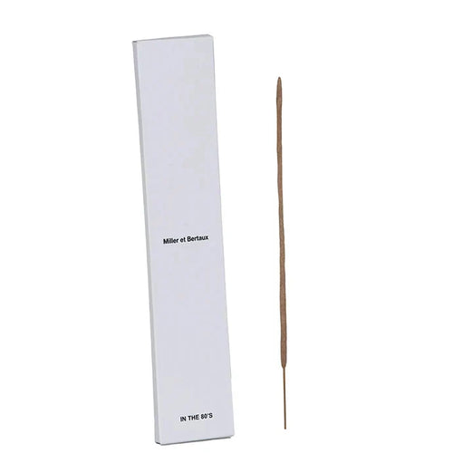 A single incense stick standing vertically next to its tall white rectangular box, which has the text 'Miller et Bertaux' and 'IN THE 80'S' printed on it, set against a white background.