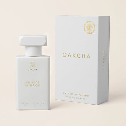 Front view of Mind’s Mirror perfume bottle and matching box with gold Oakcha logo on a cream background