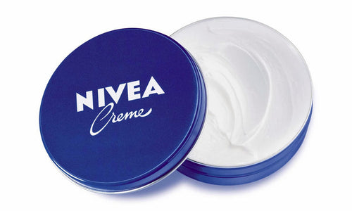 Nivea Creme jar with blue lid and white cream inside on a white background