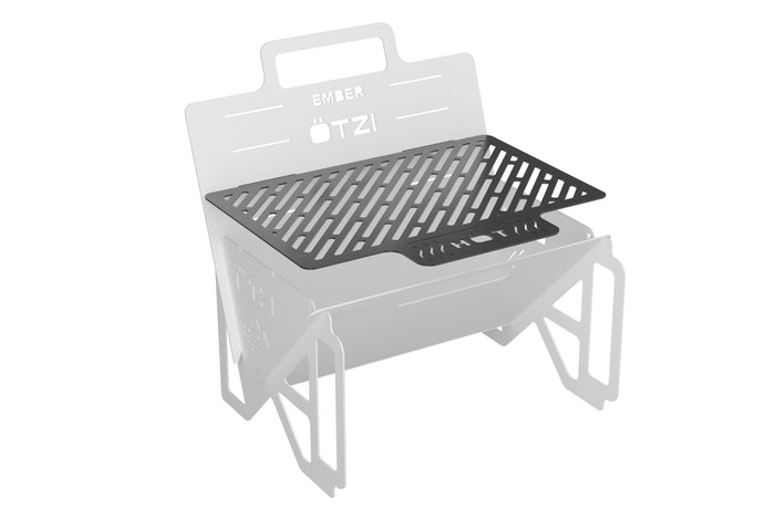 Metal grilling grate mounted on a foldable portable fire pit frame
