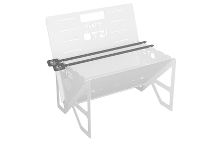 Black skewers resting on a metal outdoor grill frame with cutout details