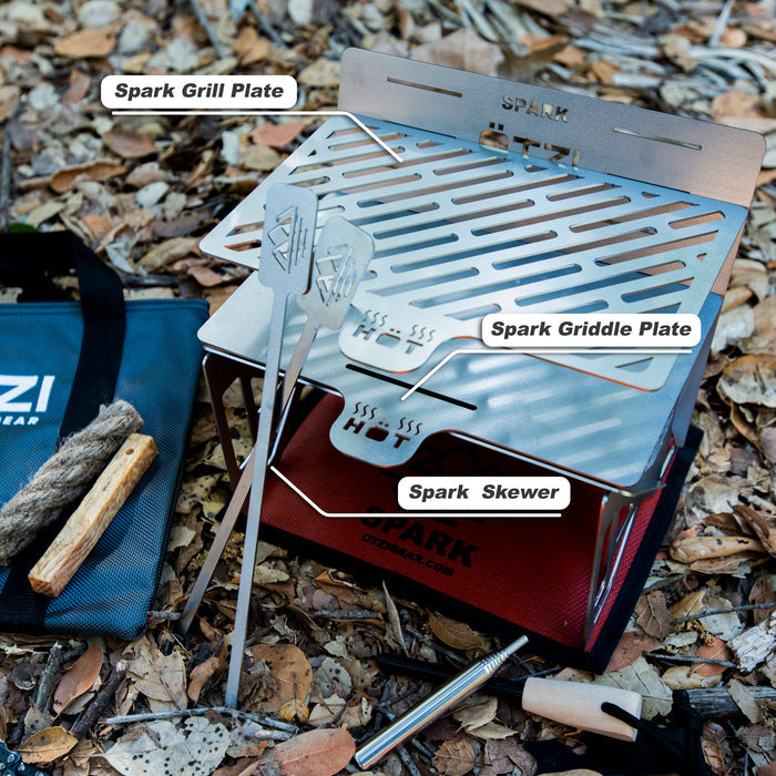 Portable grill setup with labeled stainless steel grill plate, griddle plate, and skewer on a red box.