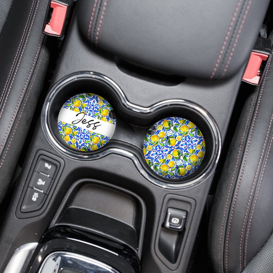 Pair of bright Amalfi Lemon car coasters by Coconut Lane, one personalised with “Jess” in cursive.