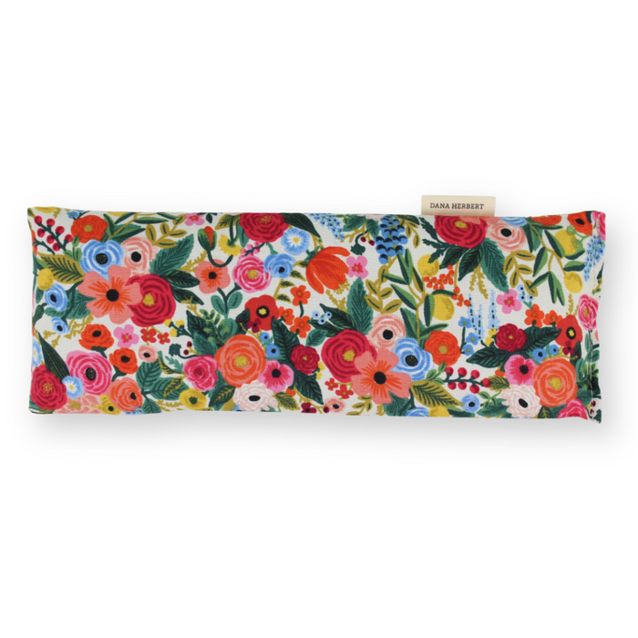 An eye pillow with a vibrant multicolor floral print