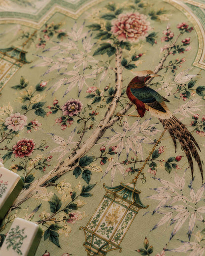 Floral mahjong table mat close-up with pink blossoms, leaves, and bird illustration