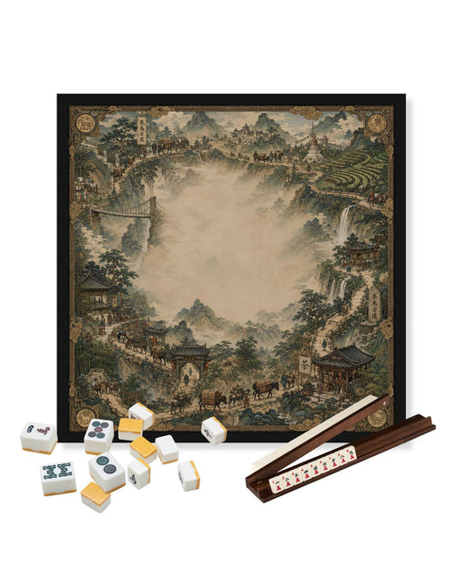 Square mahjong table mat with tea-road landscape print and black frame, used with tiles