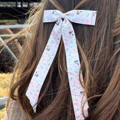 White ribbon bow clip with bunny and floral print.
