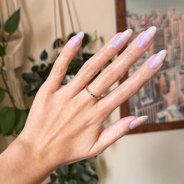 Rose Glaze - Builder Gel on natural long nails with sheer pink iridescent manicure in warm indoor setting