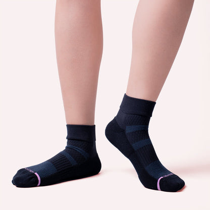 Quarter-length compression socks in dark blue with striped design and pink accents.