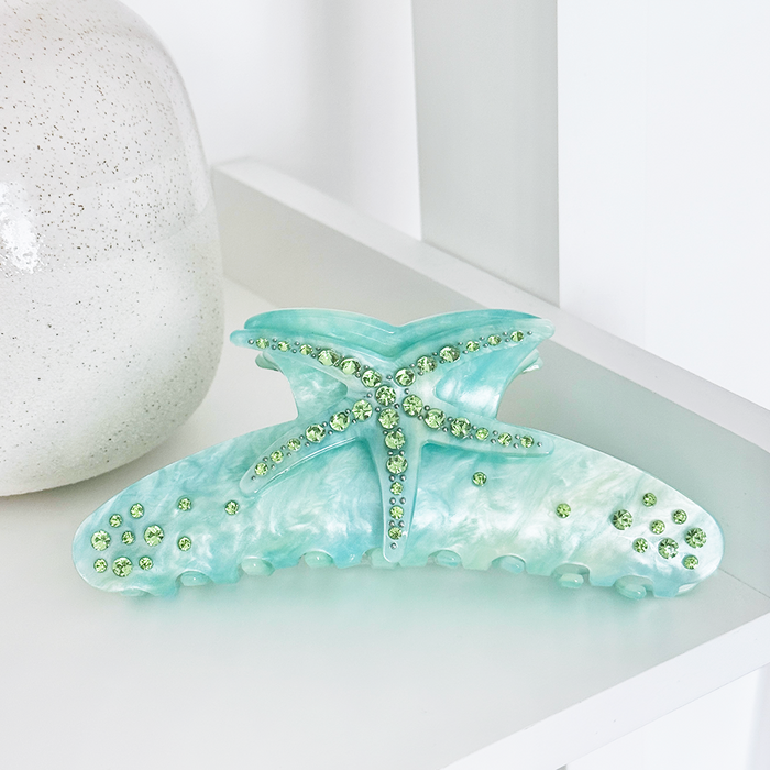 Seafoam green Coconut Lane starfish claw clip with green rhinestones, shown on a white surface.