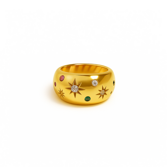 Gold signet ring with star engravings and small diamond, emerald, and ruby gemstones.