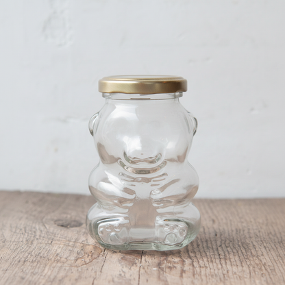 maman teddy bear glass jar with gold lid — open view on rustic wood