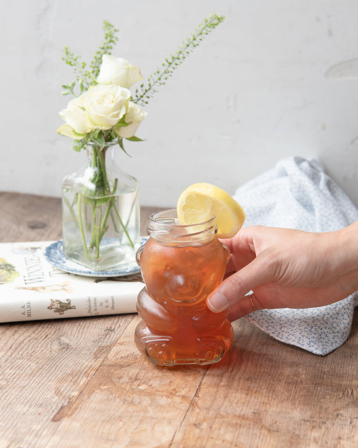 maman teddy bear glass jar with gold lid used as drinking glass with juice and lemon