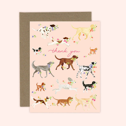 Greeting card with illustrations of dogs and flowers on a pink background, featuring the text 'thank you'.