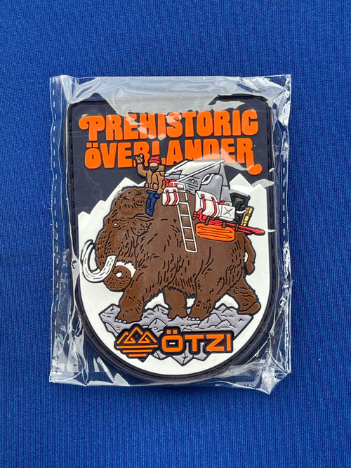 Prehistoric Overlander patch showing a mammoth carrying camping gear across snowy terrain.