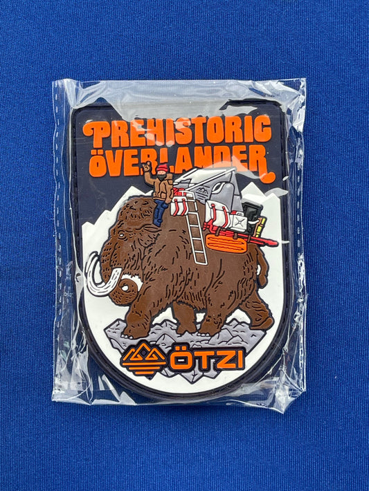 Prehistoric Overlander patch showing a mammoth carrying camping gear across snowy terrain.