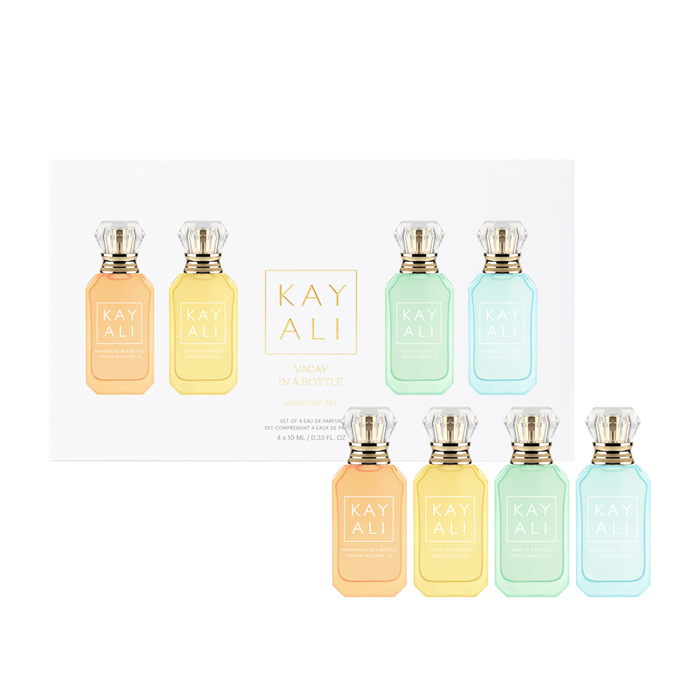 Set of eight Kayali perfume bottles in various pastel colors on a white background.
