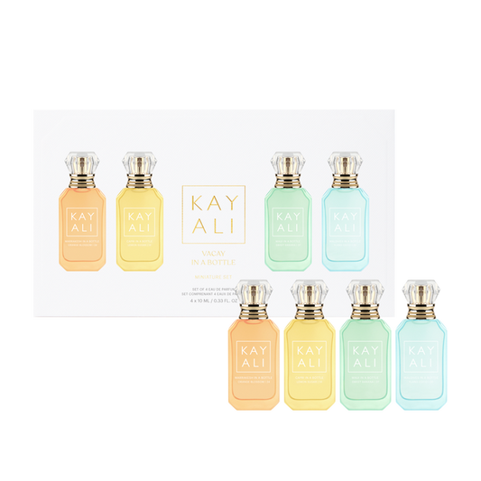 Set of eight Kayali perfume bottles in various pastel colors on a white background.