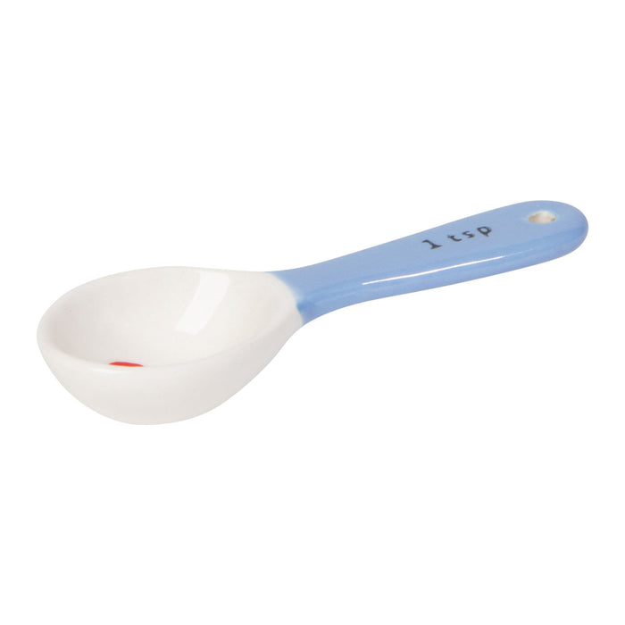 White measuring spoon with blue handle on a white background