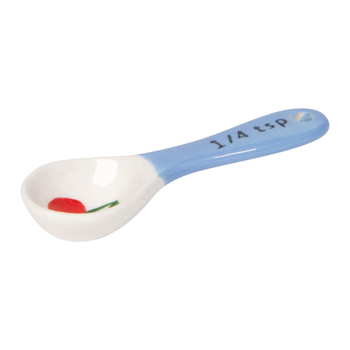 Spoon with cherry design and measurement markings on a white background