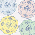 Four decorative plates with floral patterns in pastel colors on a light background