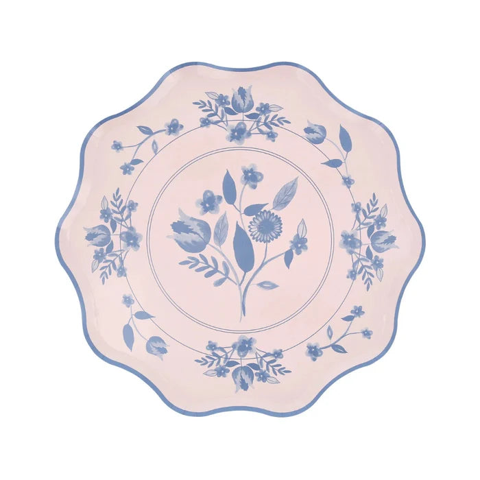Decorative plate with blue floral pattern on a pink background
