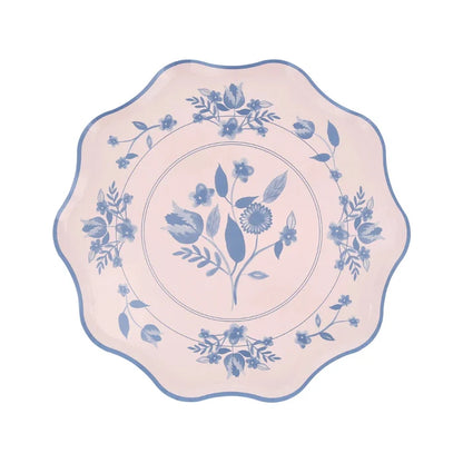 Decorative plate with blue floral pattern on a pink background